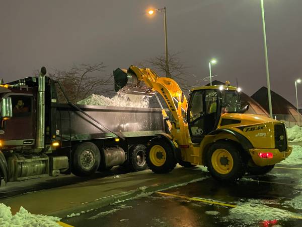 Lauder loading a tri-axle dump truck full of snow